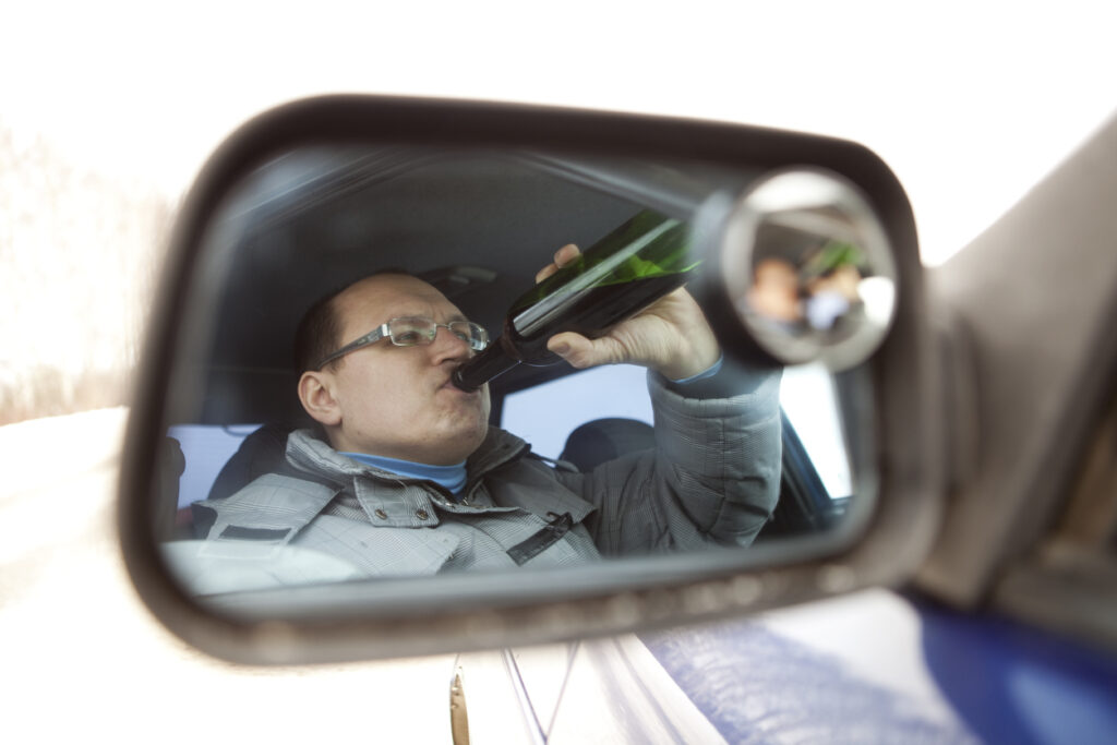 Man drinking in vehicle